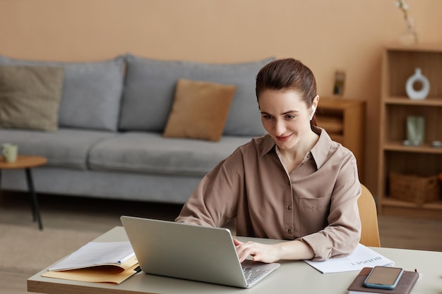 Young businesswoman enjoying work from home and using laptop