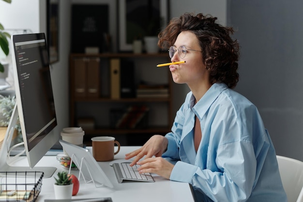 Young businesswoman fooling around at her workplace