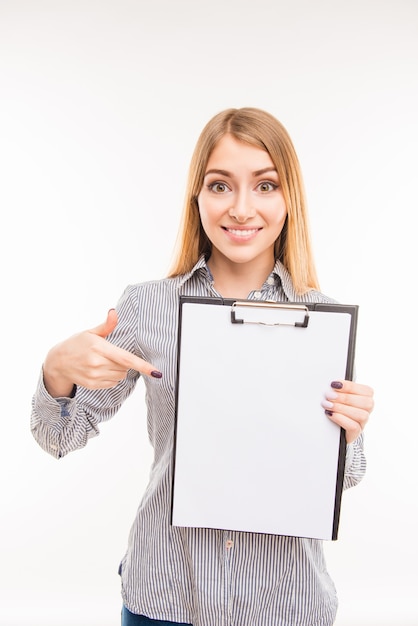 Young businesswoman holding blank clipboard