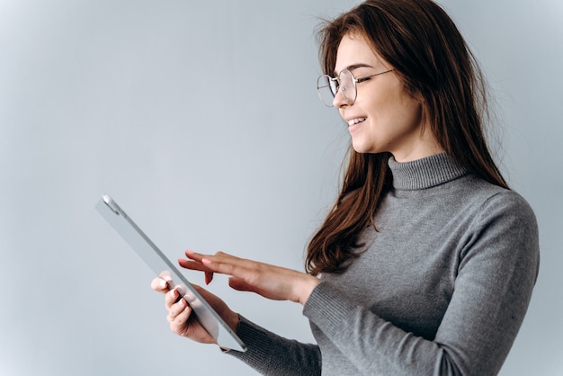 Young businesswoman holding a digital tablet and looking at it