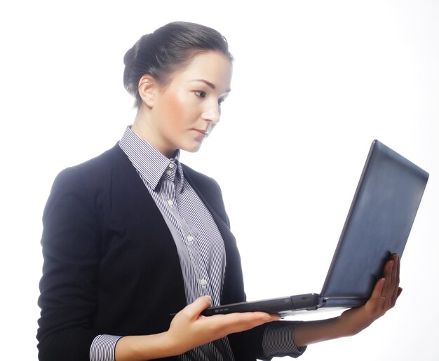 Young businesswoman holding a laptop