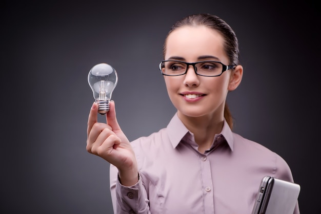 Young businesswoman in idea concept with light bulb