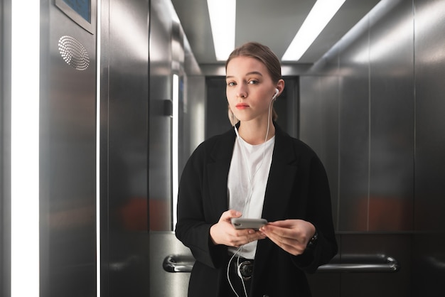 Young businesswoman is seriously looking at the camera