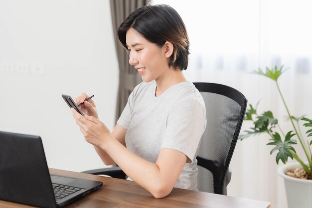 A young businesswoman is very happy after checking her email through her laptop