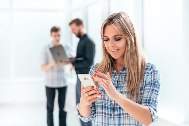 Young businesswoman looking at the screen of her smartphone