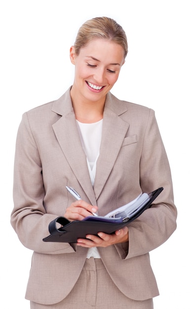 Young businesswoman making notes on her agenda 