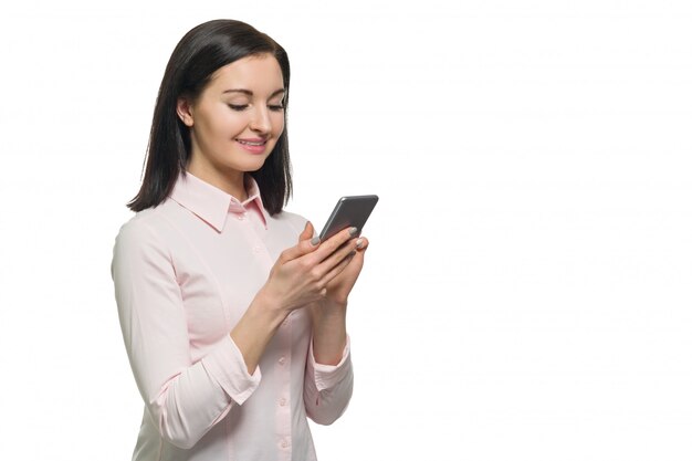 Young businesswoman in pink shirt using mobile phone 