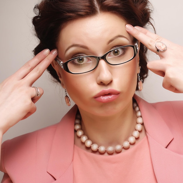 Young businesswoman in pink wearing glasses. Funny pictures.