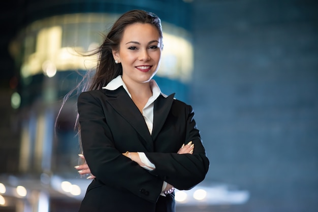 Young businesswoman portrait in a modern city setting at night