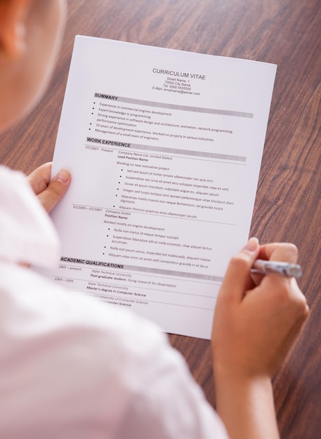 Young Businesswoman Reading Curriculum Vitae