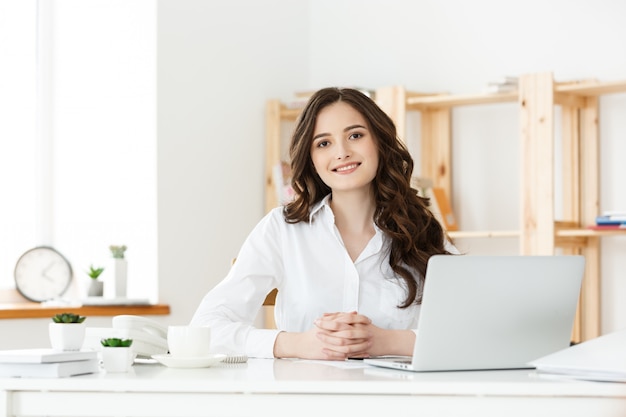 Young businesswoman or secretary sitting at desk and working.