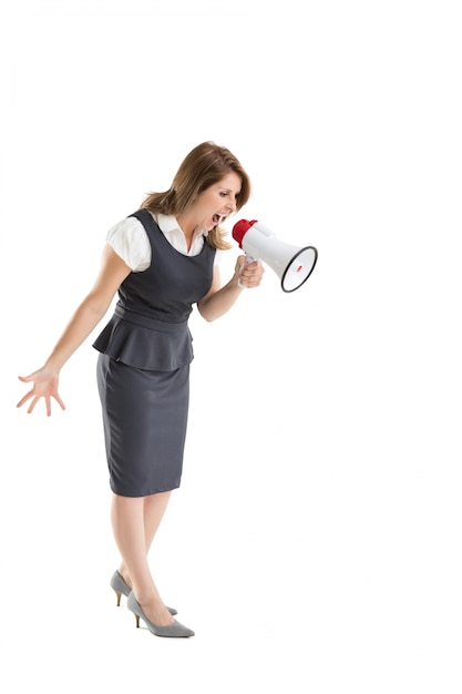 Young businesswoman shouting into bullhorn