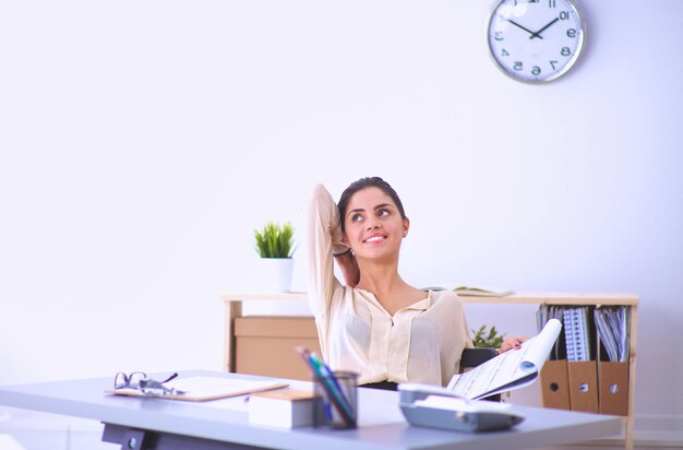 Young businesswoman sitting and talking on phone