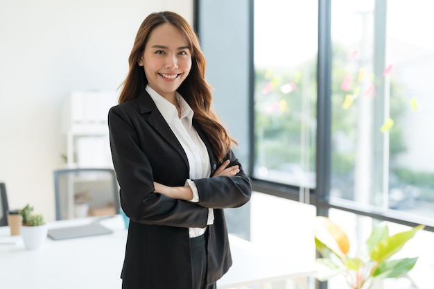 Young businesswoman standing with crossed arms smiling