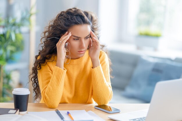 Young businesswoman studying online watching webinar podcast on laptop