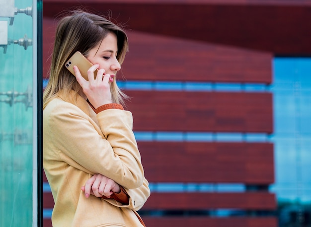 Young businesswoman talking by phone on the city square