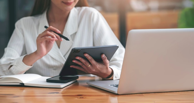 Young businesswoman using portable table with stylus pen, doing planning analyzing the financial report, business plan investment.