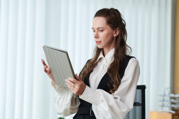 Young businesswoman using tablet pc in office