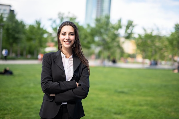 Young businesswoman walking in a city park