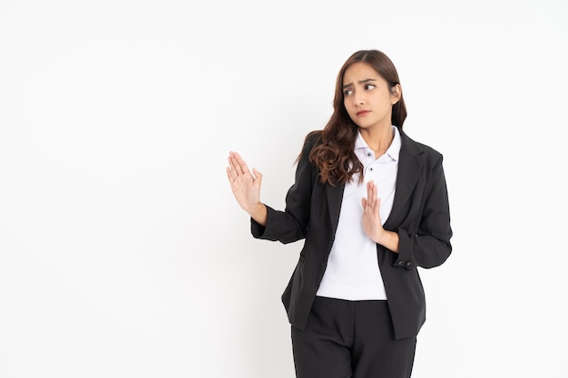 Young businesswoman wearing black suit smiling with hand gesture rejecting with copyspace