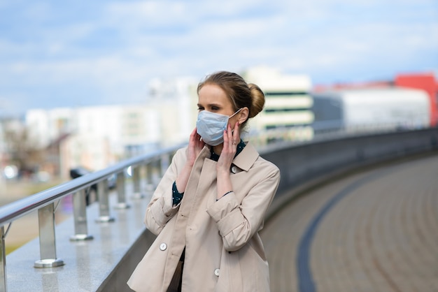 A young businesswoman wearing a health mask in the city