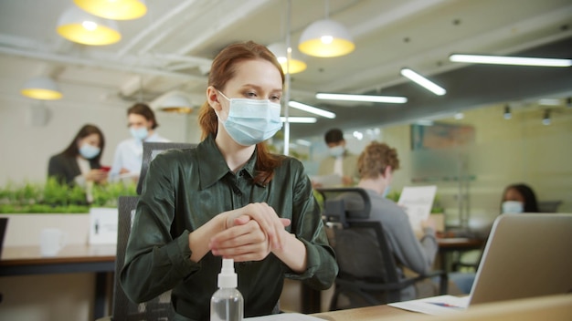 Young businesswoman wearing mask at office