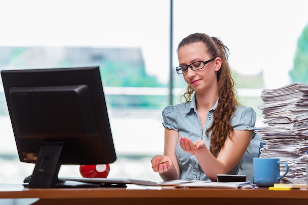 Young businesswoman with coins in the office