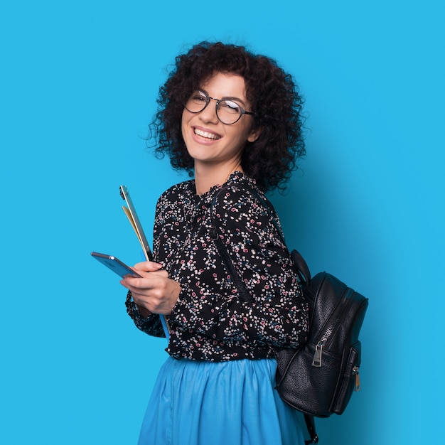 Young businesswoman with curly hair smiling