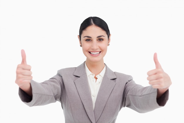 Young businesswoman with a smile giving thumbs up