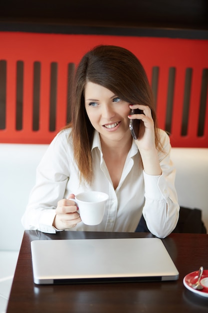 Young businesswoman working at cafe