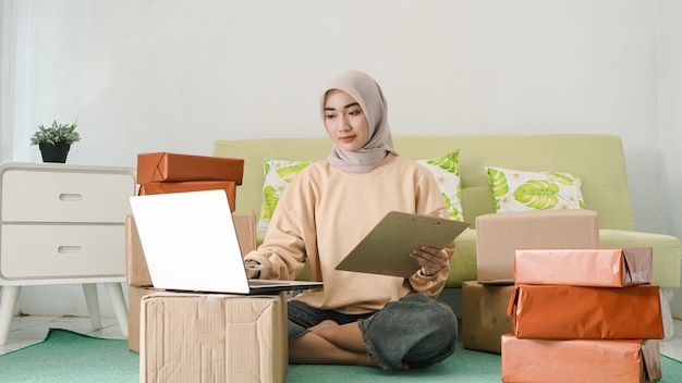 Young businesswoman working using laptop in the room