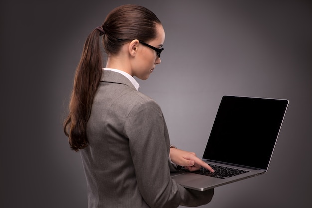 Young businesswoman working with laptop in business concept