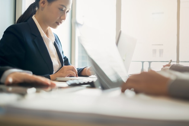 young businesswoman working with mobile laptop and documentsin office