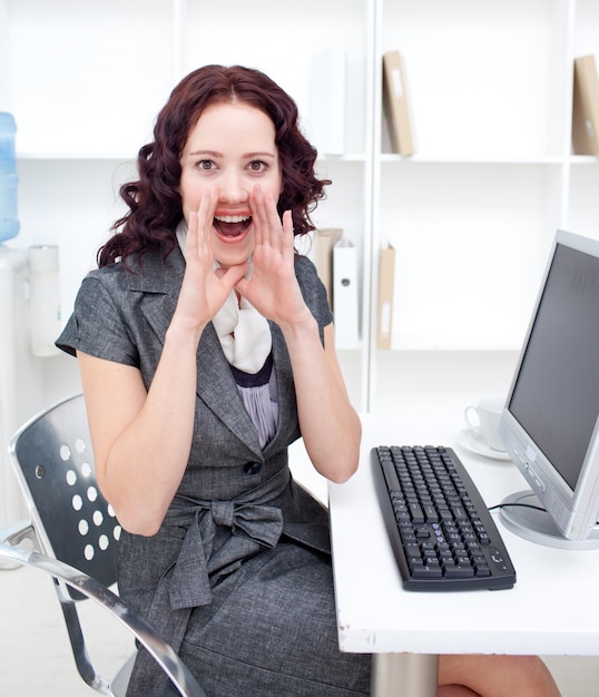 Young businesswoman yelling in office