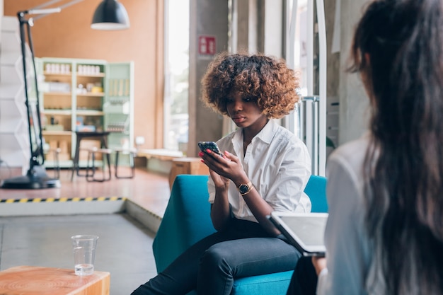 young businesswomen working with smart device in modern office 