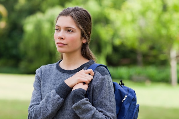 Young calm girl looking towards the side while standing in the countryside