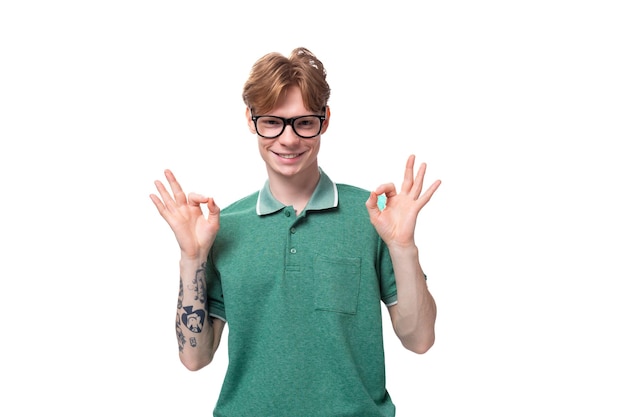 Photo young calm smart man with red hair in glasses meditates