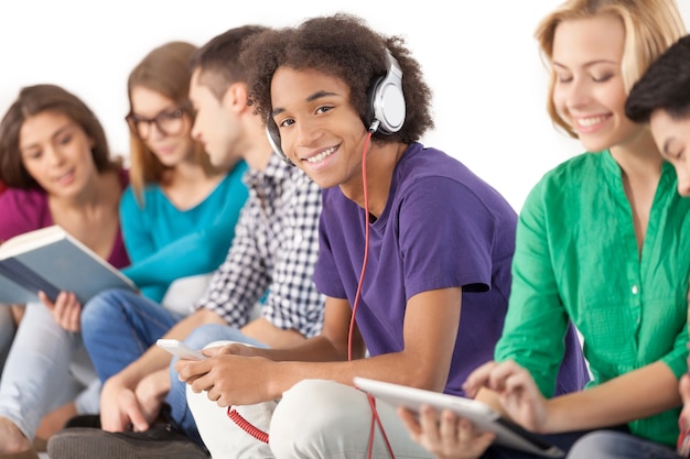 Young and carefree. Group of multi-ethnic students spending time together while isolated on white