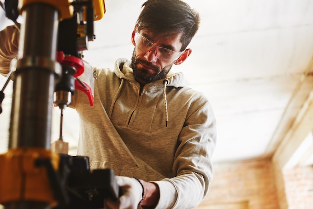 The young carpenter works in a workshop