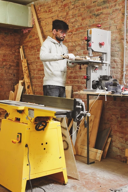 The young carpenter works in a workshop