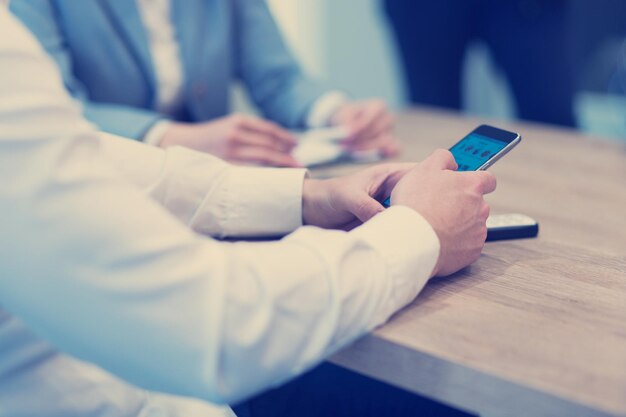 Young casual businessman using smartphone in the startup office