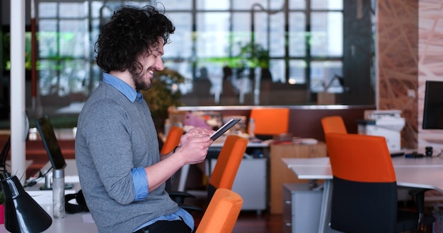 young casual businessman using tablet computer in startup office