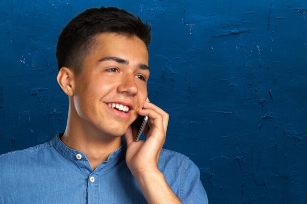 Young casual happy man on the phone