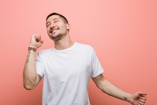 Young casual man dancing and having fun.