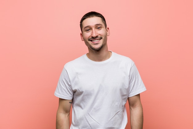 Young casual man happy, smiling and cheerful.