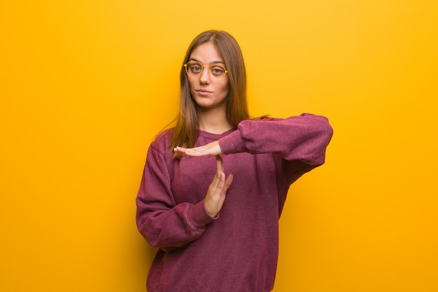 Young casual woman doing a timeout gesture