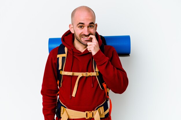 Young caucasian backpacker bald man isolated on white background biting fingernails, nervous and very anxious.