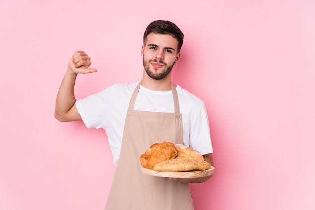 Young caucasian baker man isolated feels proud and self confident, example to follow.