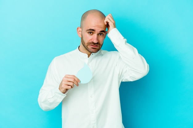 Young caucasian bald man celebrating world water day isolated on blue background being shocked