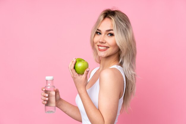 Young caucasian beauty healthy woman over isolated pink wall